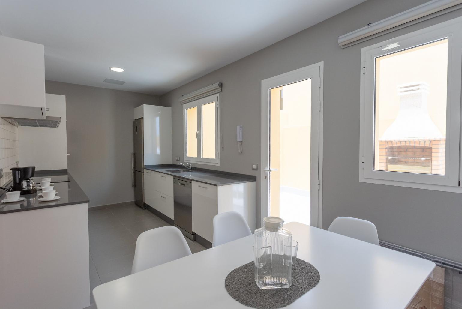 Kitchen with dining area and terrace access