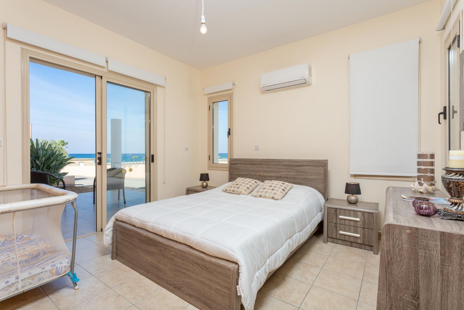 Double bedroom with en suite bathroom, A/C, and terrace access with sea views