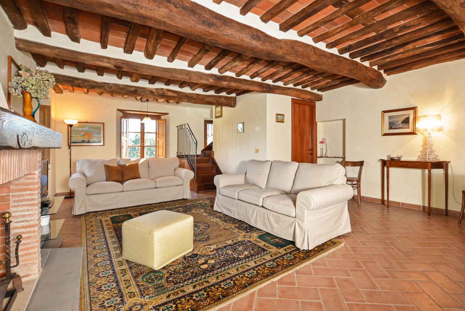 Living room with fireplace, TV and terrace access