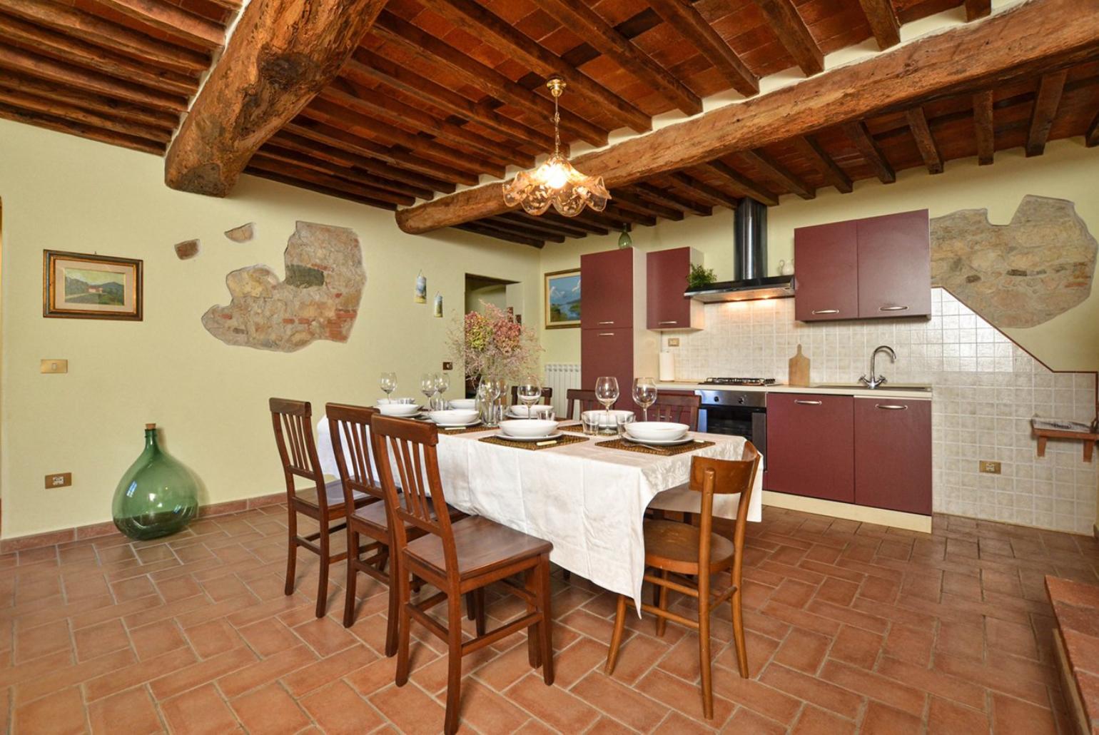 Equipped kitchen with dining area, fireplace and terrace access 