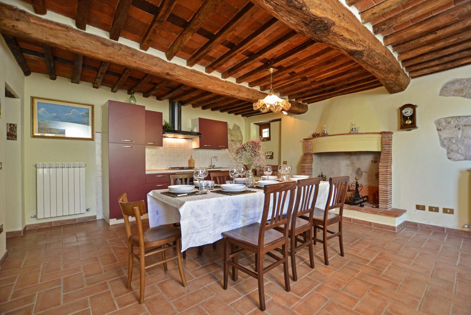 Equipped kitchen with dining area, fireplace and terrace access 