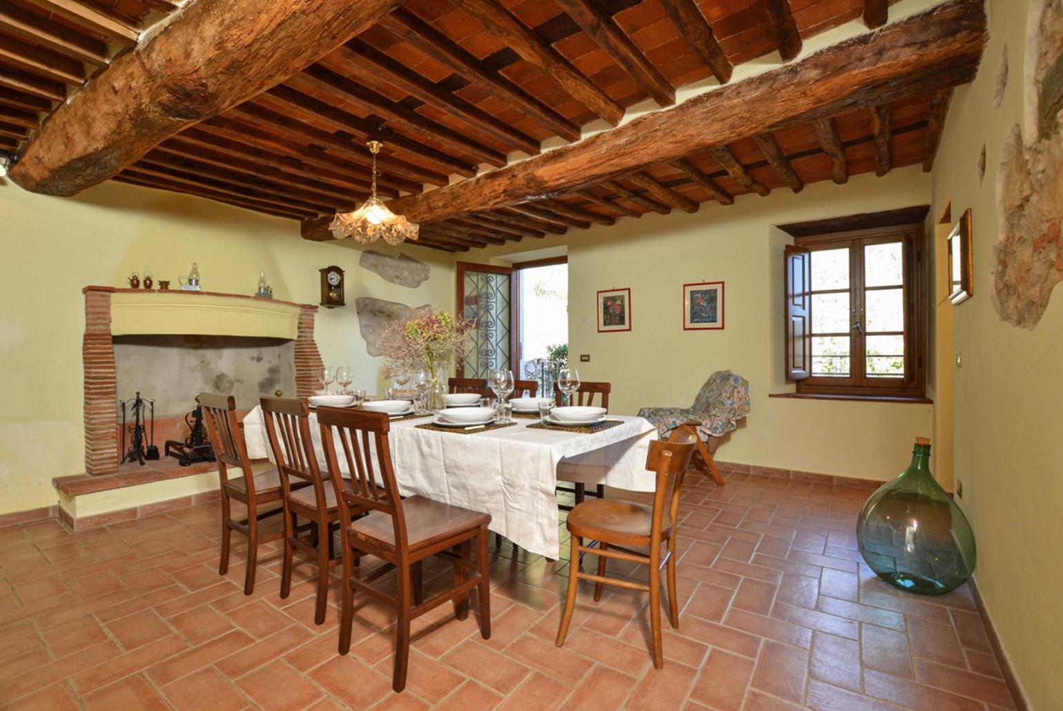 Equipped kitchen with dining area, fireplace and terrace access 