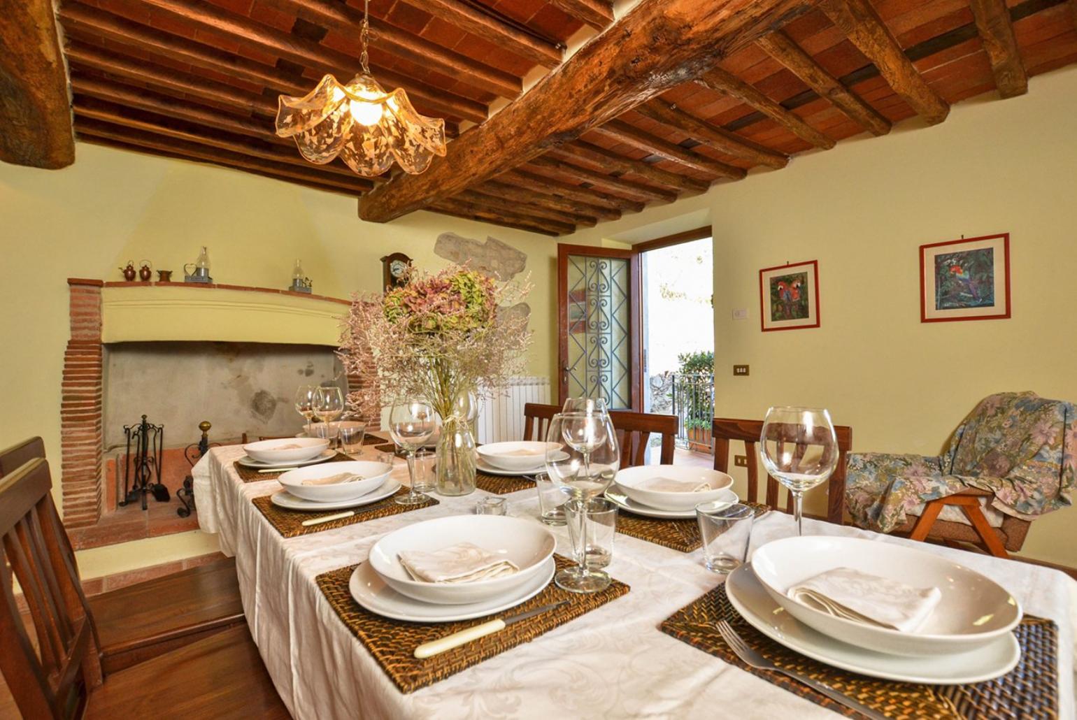 Equipped kitchen with dining area, fireplace and terrace access 