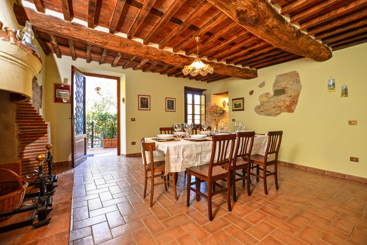 Equipped kitchen with dining area, fireplace and terrace access 