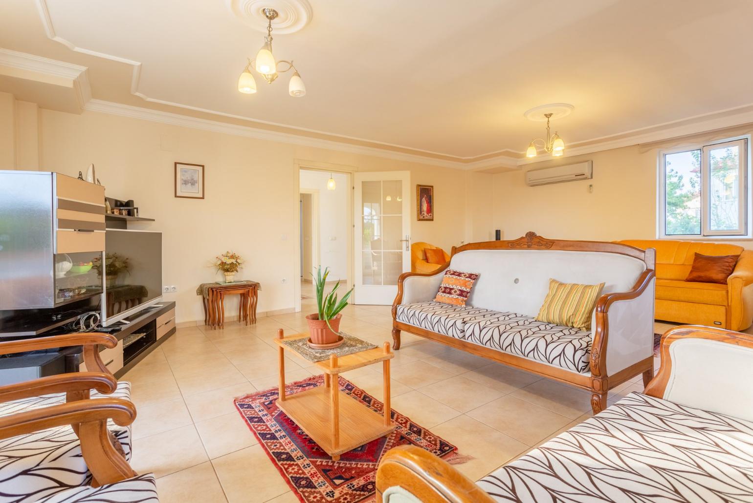 Living room with sofas, ornamental fireplace, A/C, WiFi internet, satellite TV, DVD player, and terrace access 