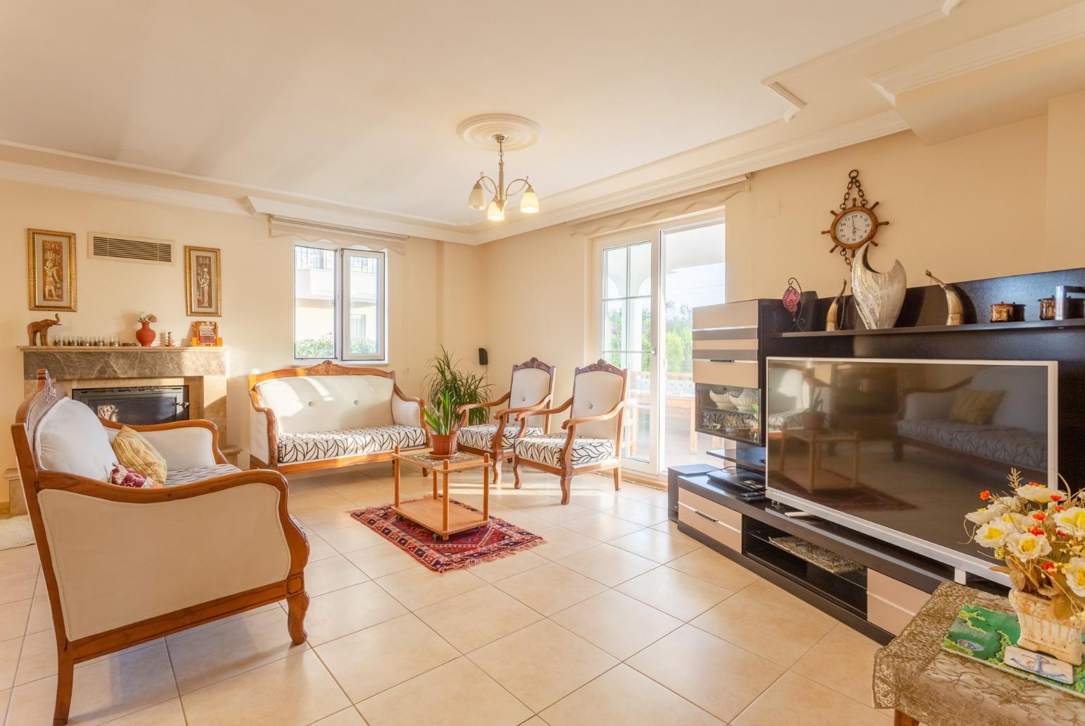 Living room with sofas, ornamental fireplace, A/C, WiFi internet, satellite TV, DVD player, and terrace access 