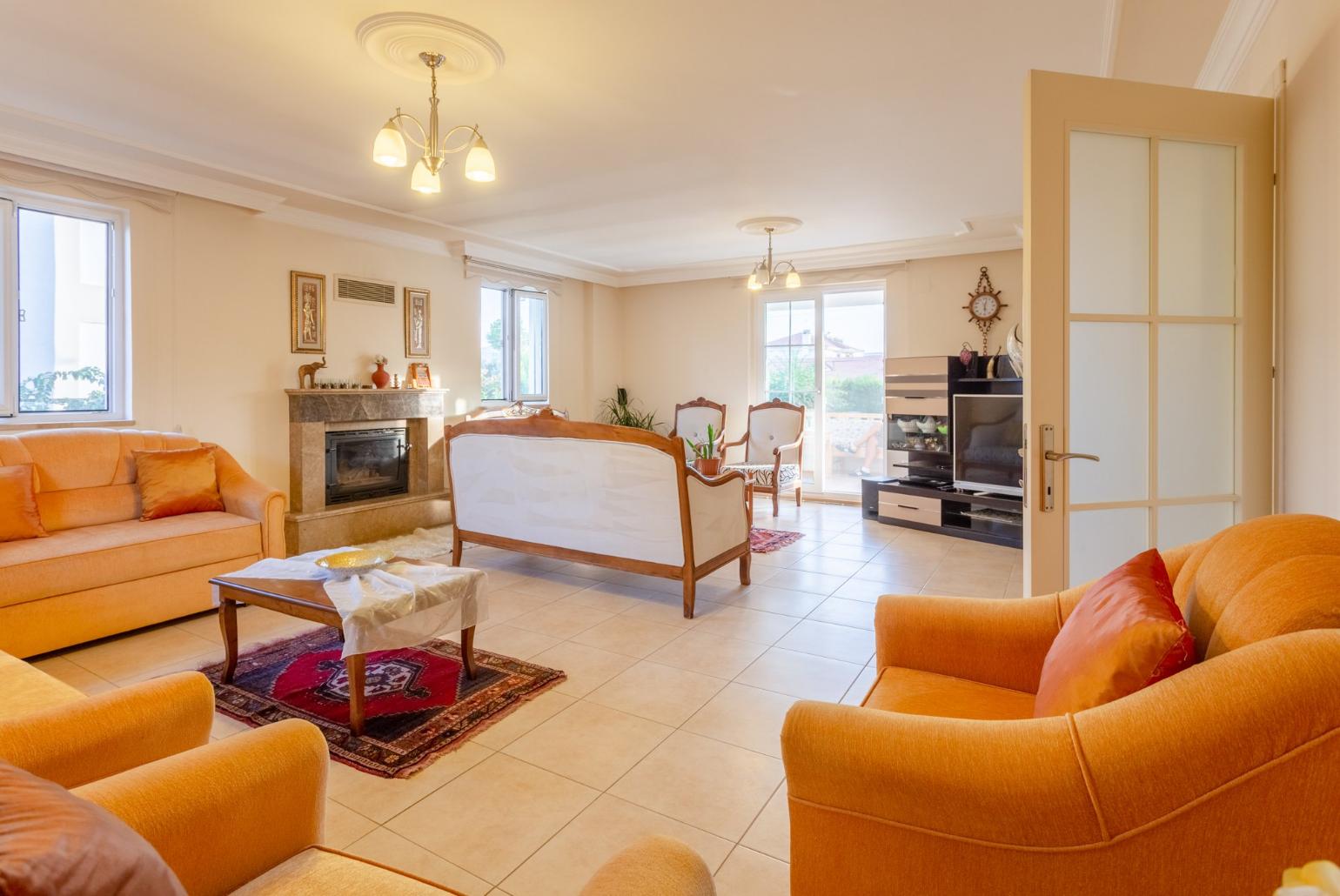 Living room with sofas, ornamental fireplace, A/C, WiFi internet, satellite TV, DVD player, and terrace access 