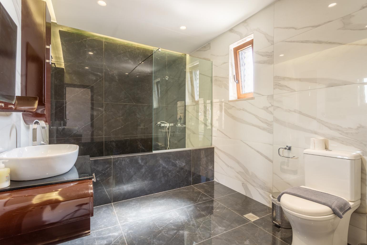 En suite bathroom with bath and shower