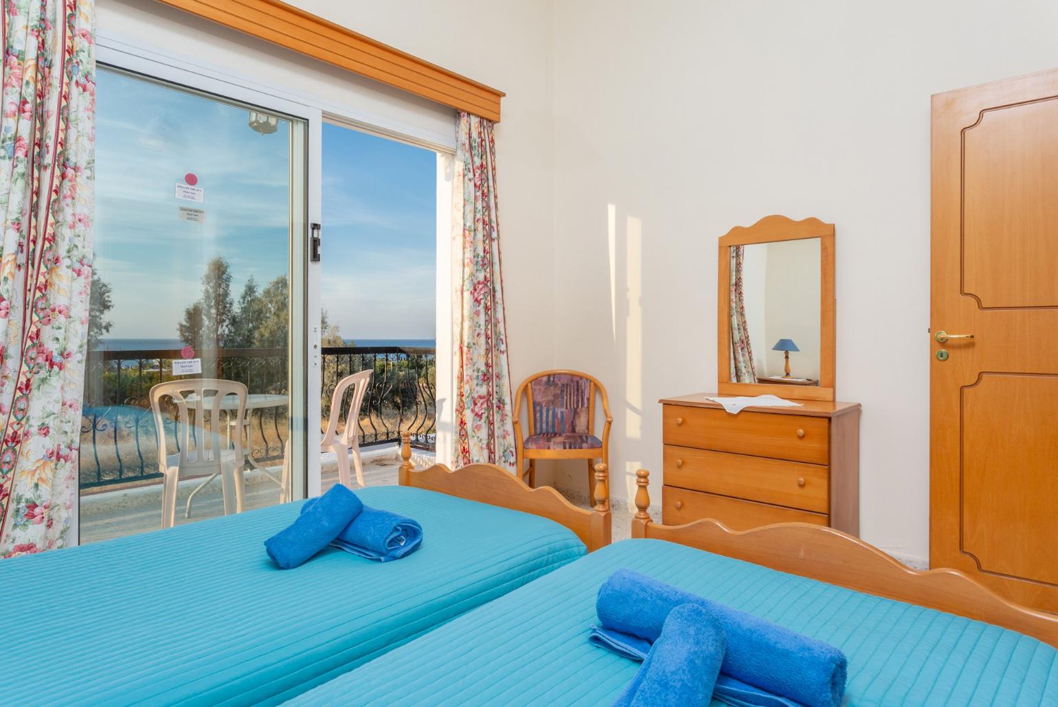 Twin bedroom with en suite bathroom, A/C, and balcony with sea views