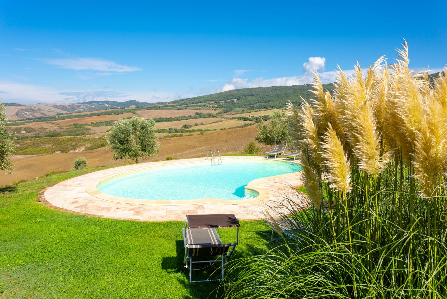 Private pool, terrace, and large lawn with panoramic Tuscan views