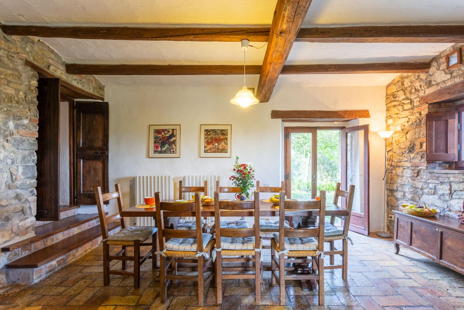 Open-plan dining area with kitchen and ornamental fireplace 