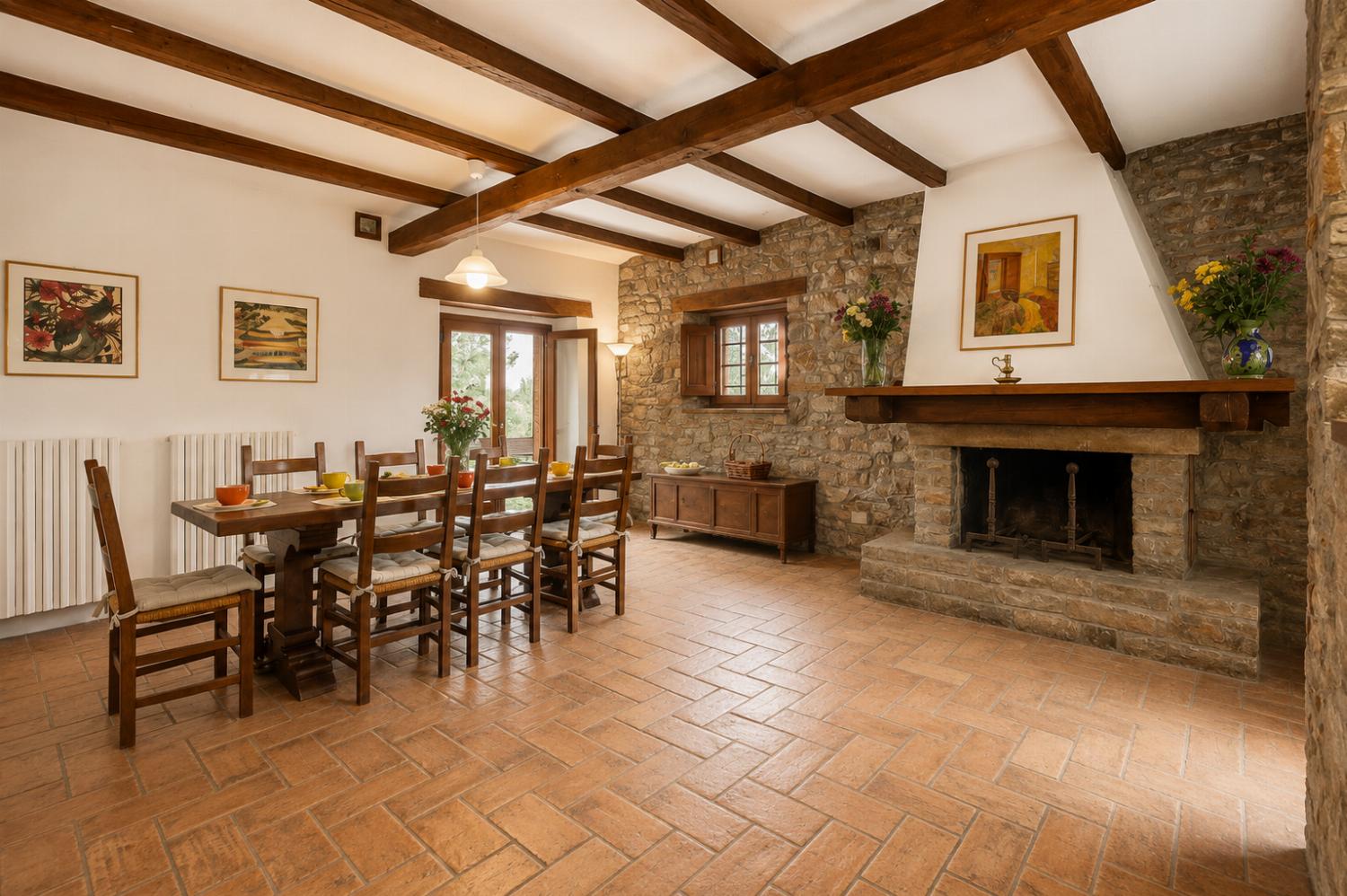Open-plan dining area with kitchen and ornamental fireplace
