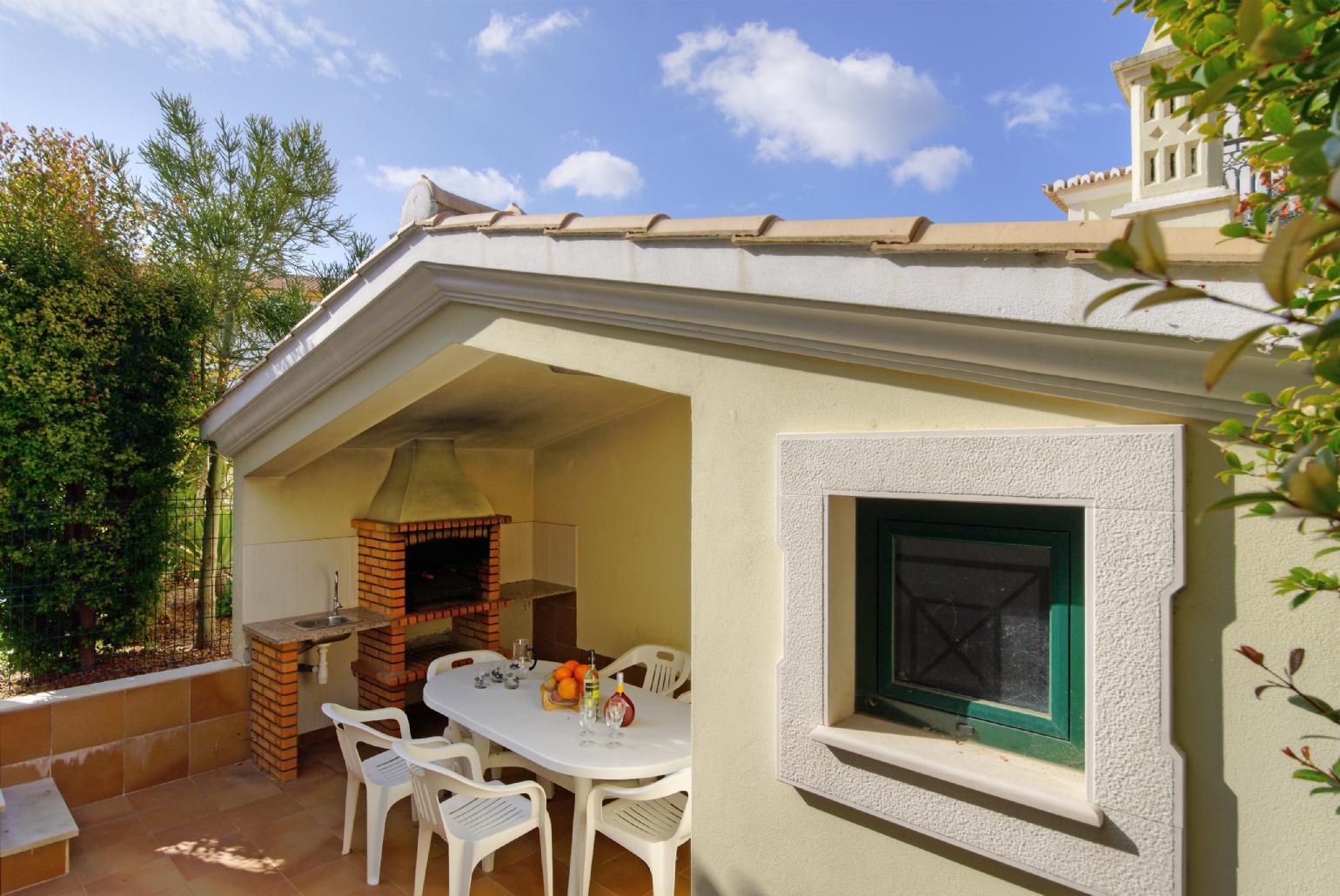 Sheltered dining area with  BBQ