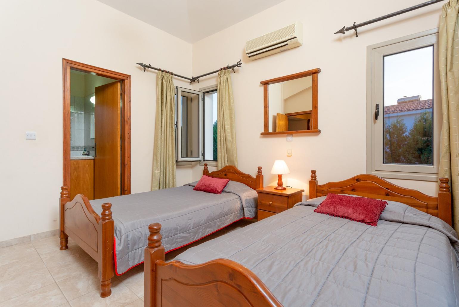 Twin bedroom with en suite bathroom, A/C, and balcony with sea views