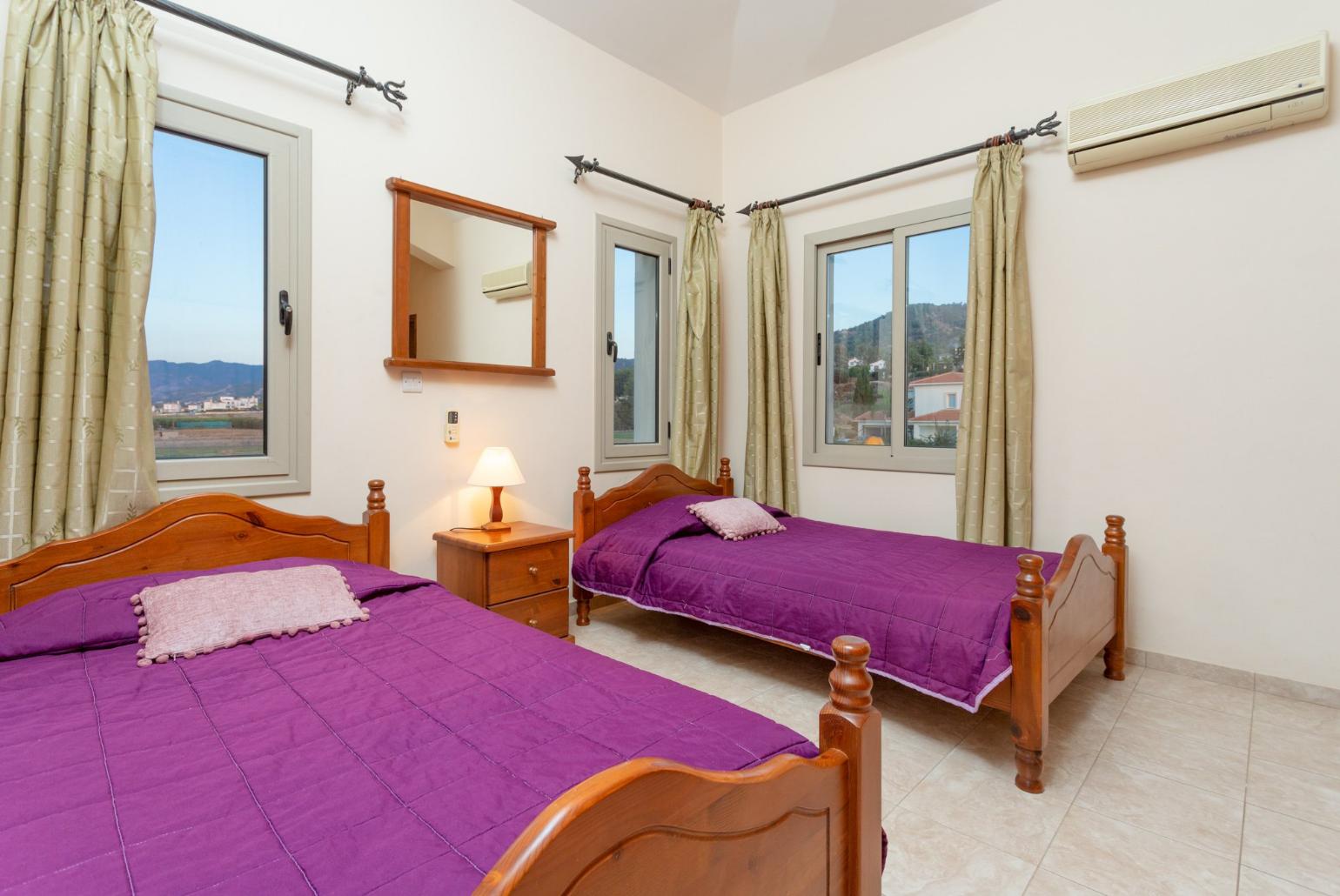 Twin bedroom with en suite bathroom, A/C, and balcony with sea views