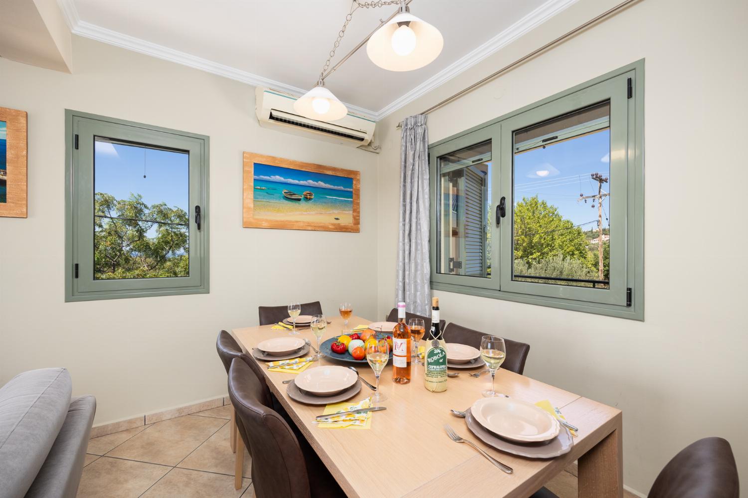 Open-plan living room with sofas, dining areas, kitchen, ornamental fireplace, A/C, WiFi internet, satellite TV, and sea views