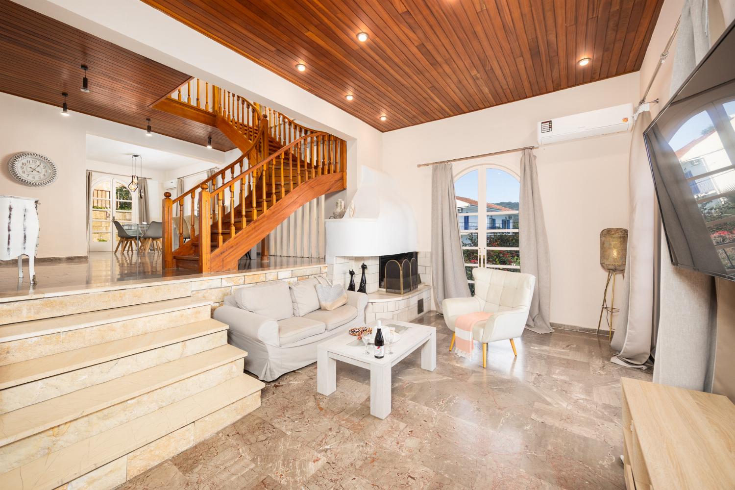 Living room with sofas, ornamental fireplace, A/C, WiFi internet, satellite TV, and sea views