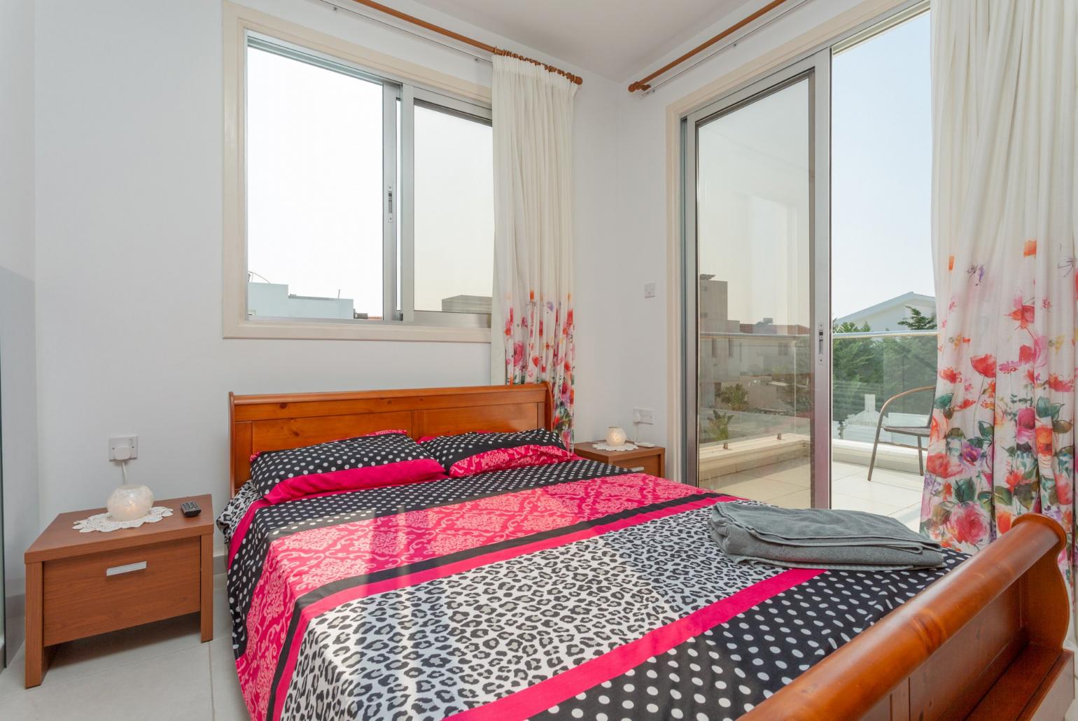 Double bedroom with A/C, satellite TV, and balcony access
