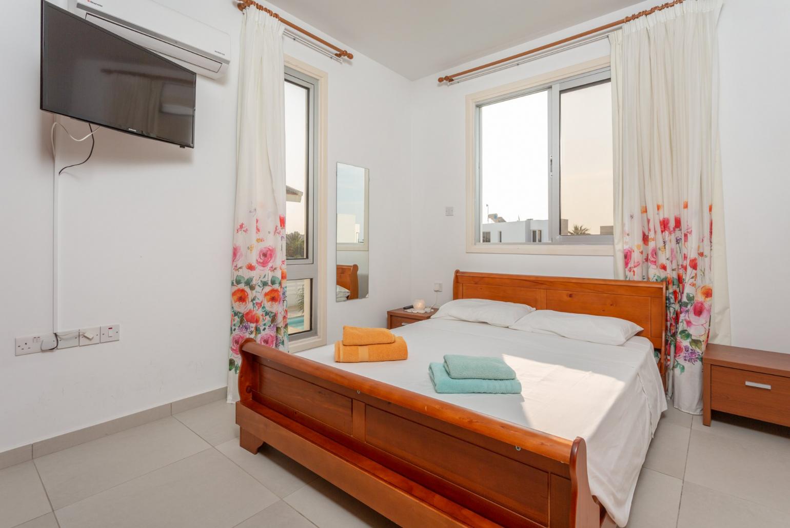 Double bedroom with A/C, satellite TV, and balcony access