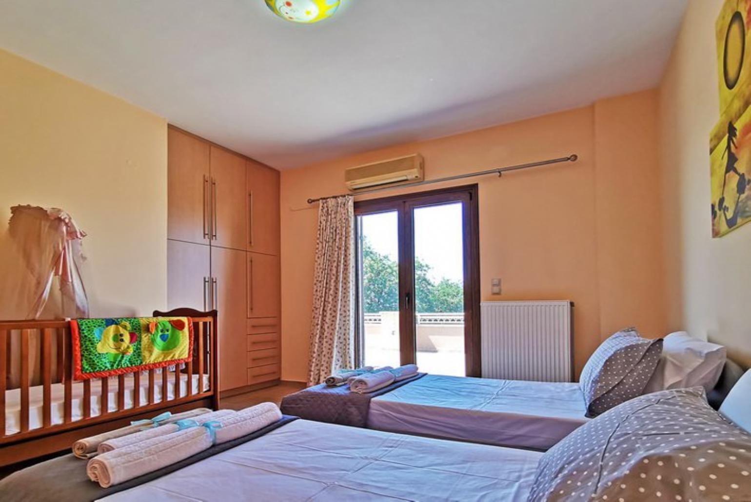 Twin bedroom and  baby cot 
