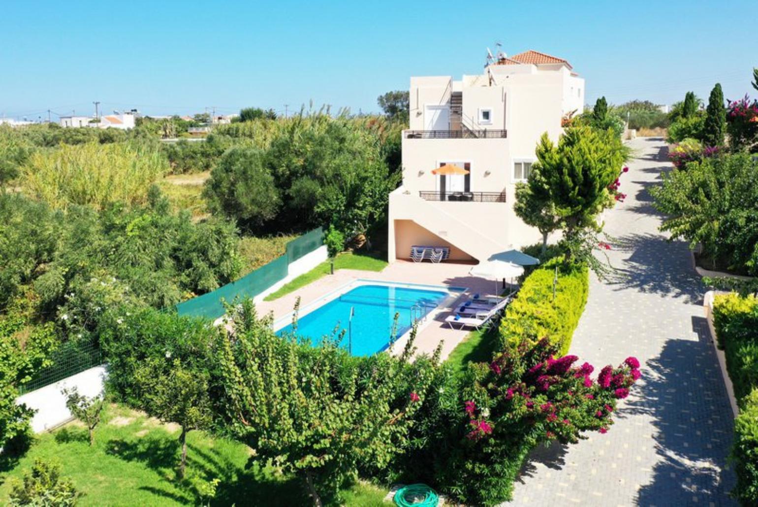,Beautiful villa with private pool, terrace, and lawn with sea views