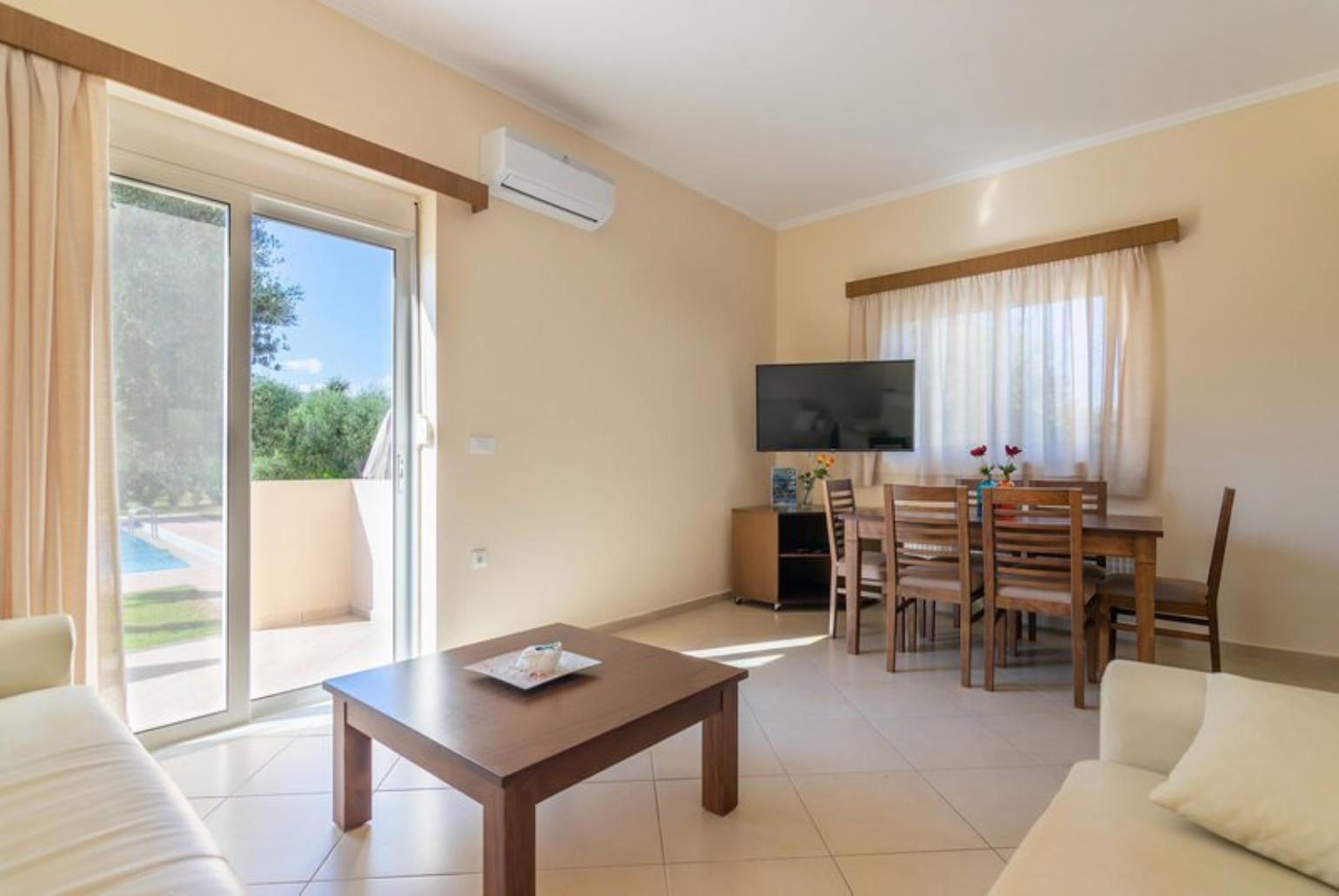 Open-plan living room with sofa, dining area