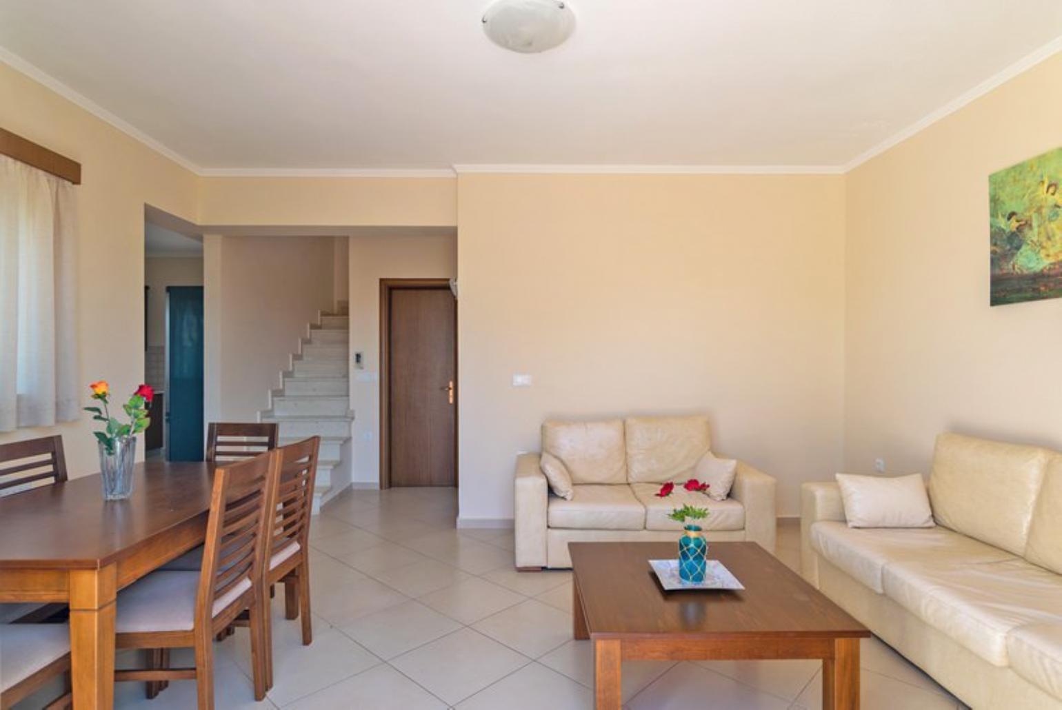 Open-plan living room with sofa, dining area