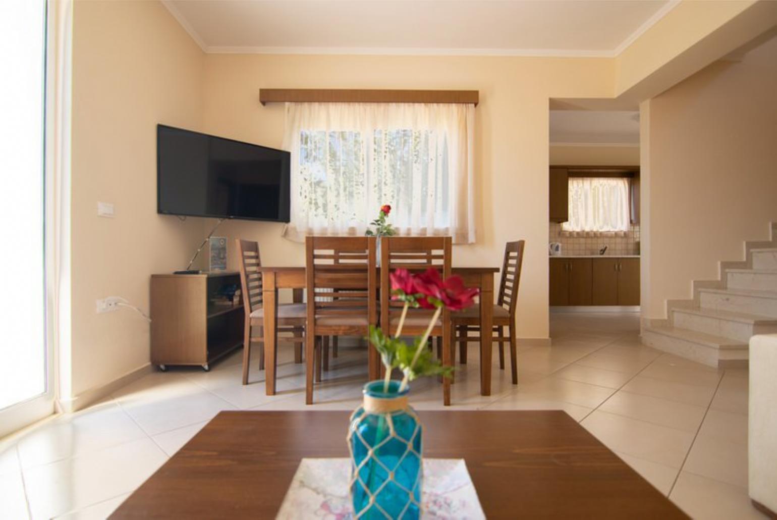 Open-plan living room with sofa, dining area