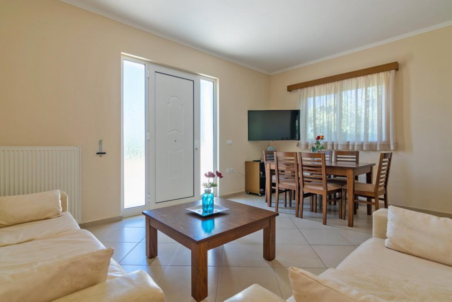 Open-plan living room with sofa, dining area