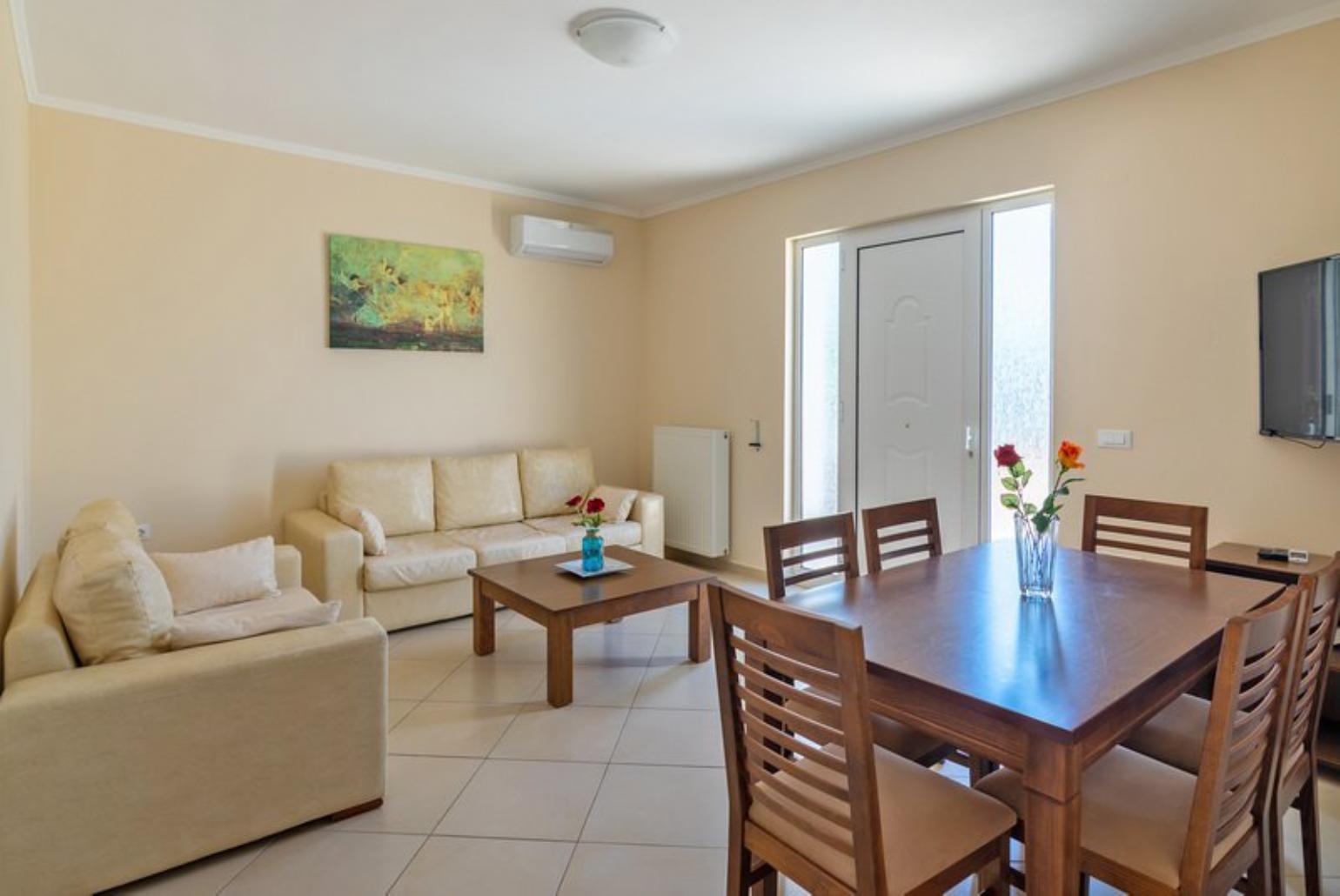 Open-plan living room with sofa, dining area