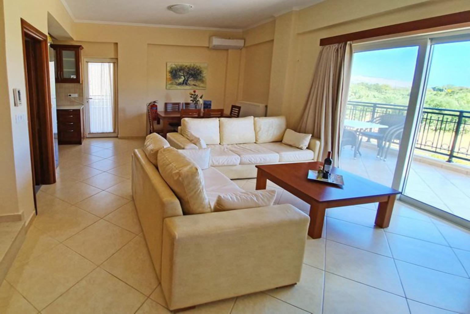 Open-plan living room with sofa, dining area