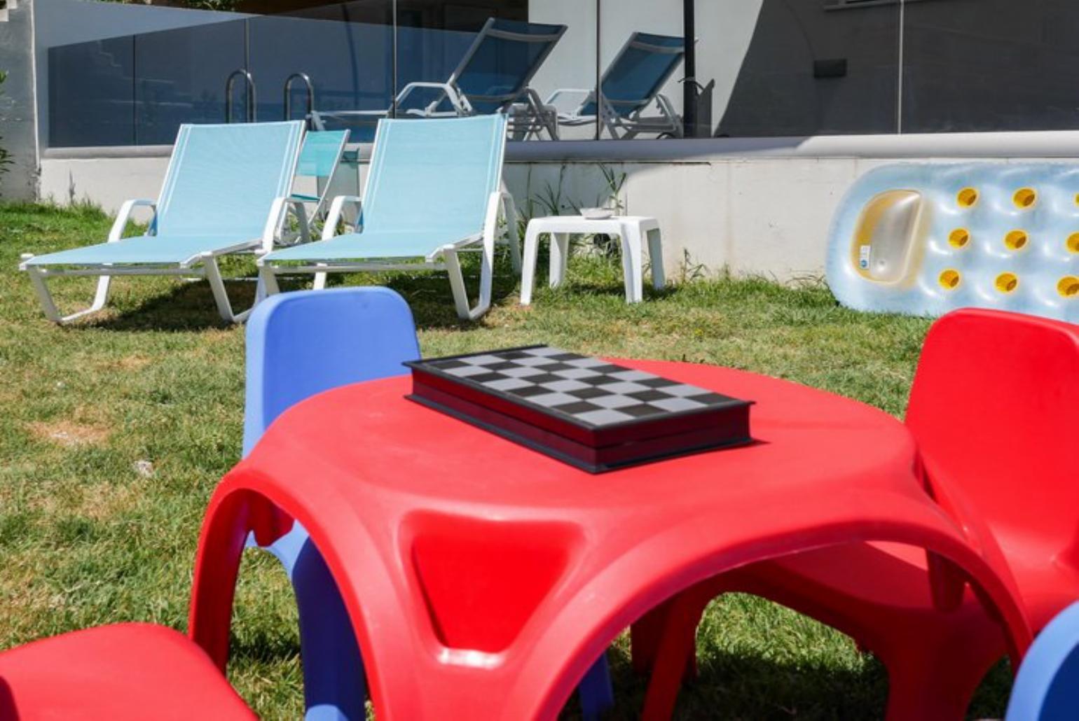 Outdoor area with sunbeds and playground