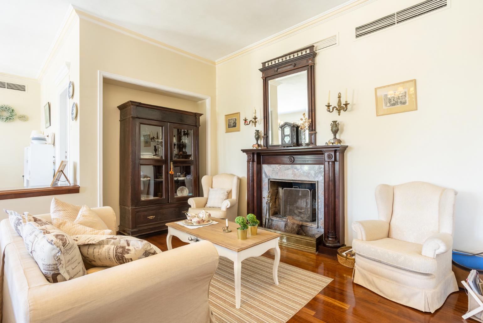 Living room with sofas, dining area, ornamental fireplace, WiFi internet, and satellite TV