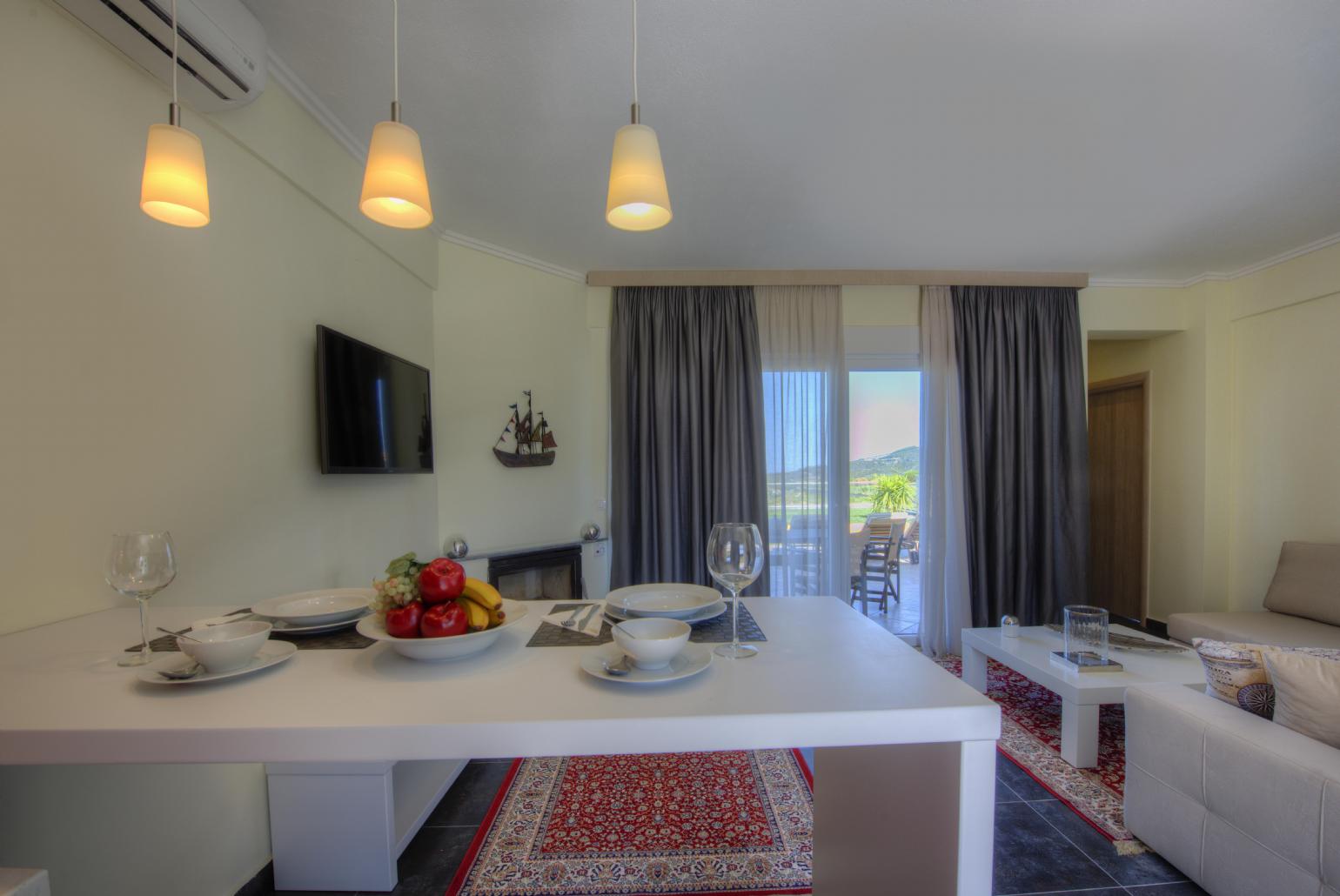 Living room with dining area and terrace access