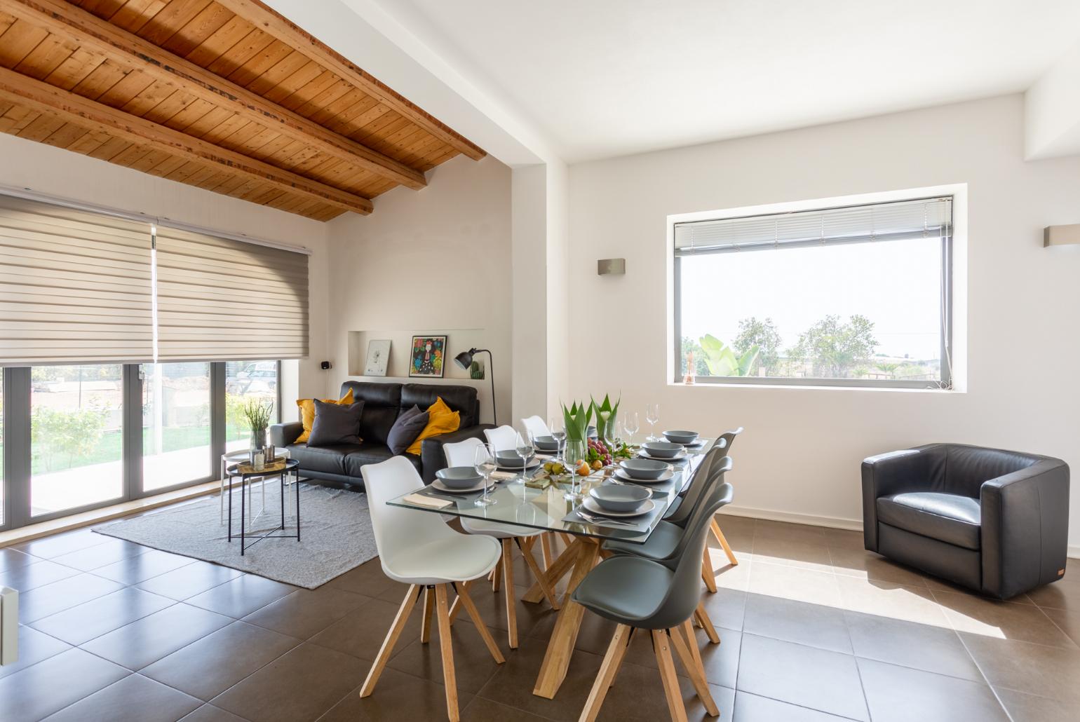 Living room with sofa, dining area, ornamental fireplace, A/C, WiFi internet, satellite TV, and terrace access