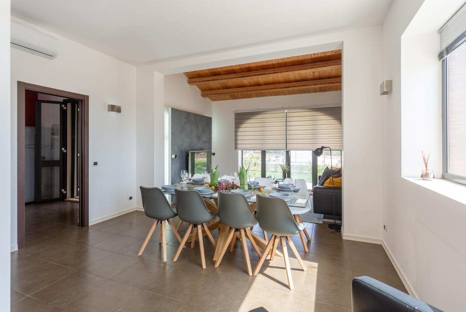 Living room with sofa, dining area, ornamental fireplace, A/C, WiFi internet, satellite TV, and terrace access