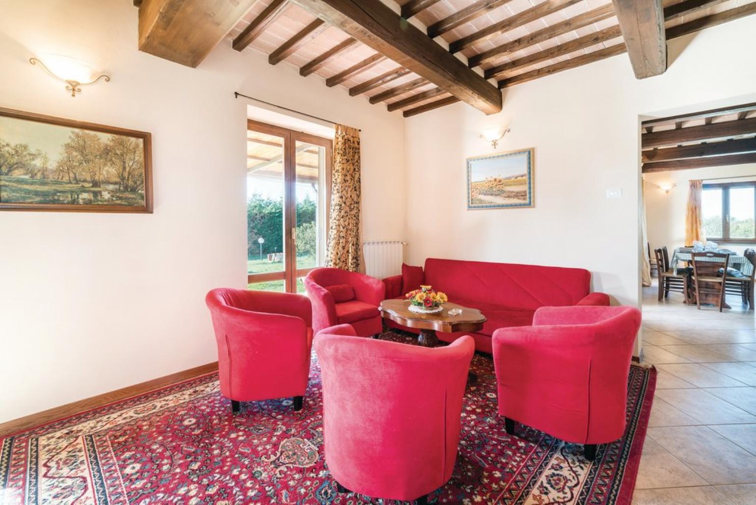 Open-plan living room with sofas, DVD player and dining area.