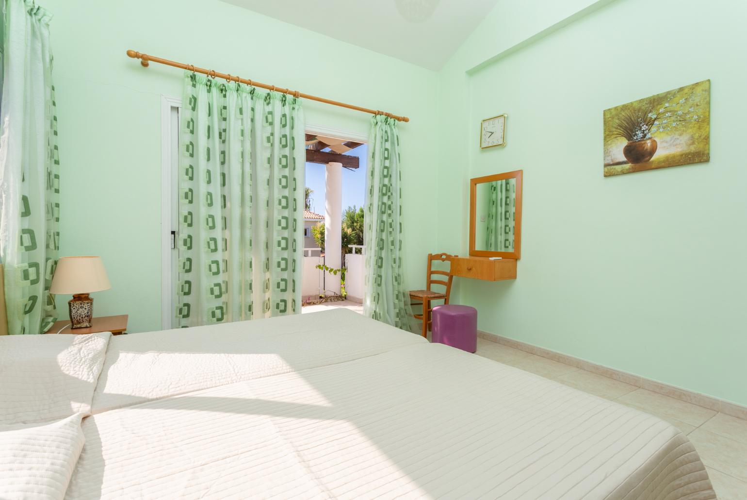 Twin bedroom with en suite bathroom, A/C, and balcony access