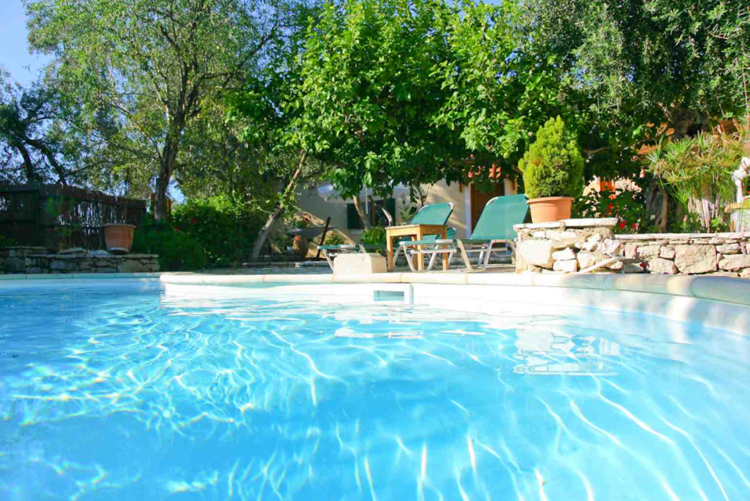 Swimming pool with sun loungers