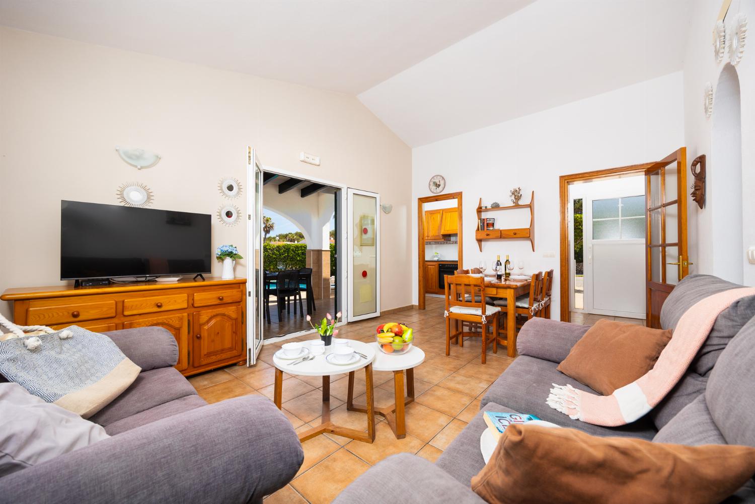 Living room with sofa, dining area, WiFi internet, and satellite TV