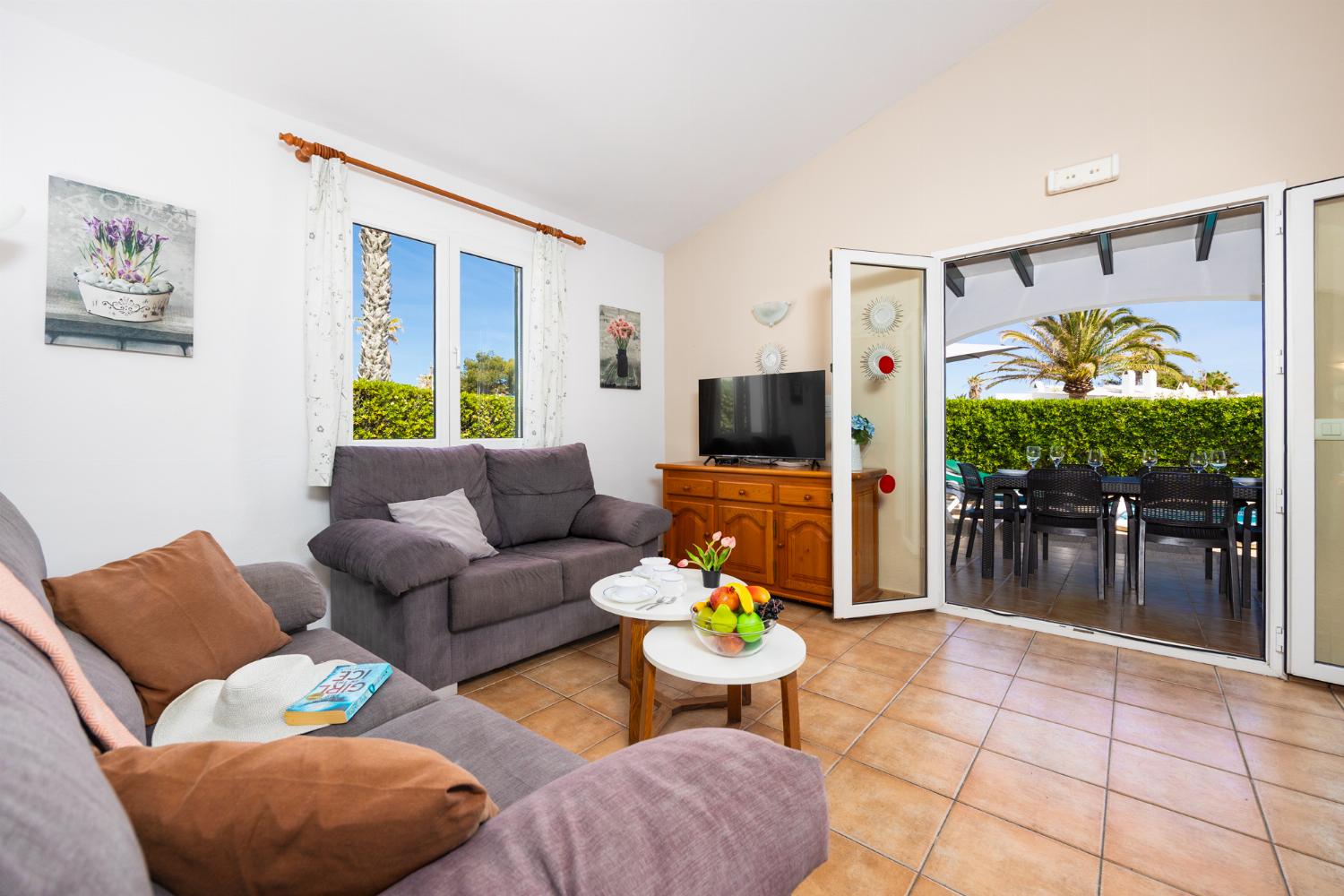 Living room with sofa, dining area, WiFi internet, and satellite TV