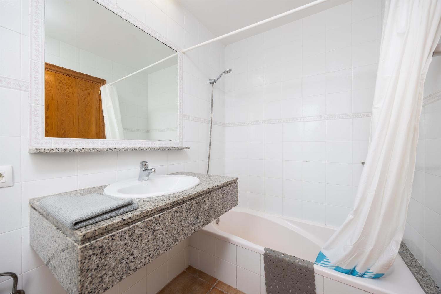 En suite bathroom with bath and shower
