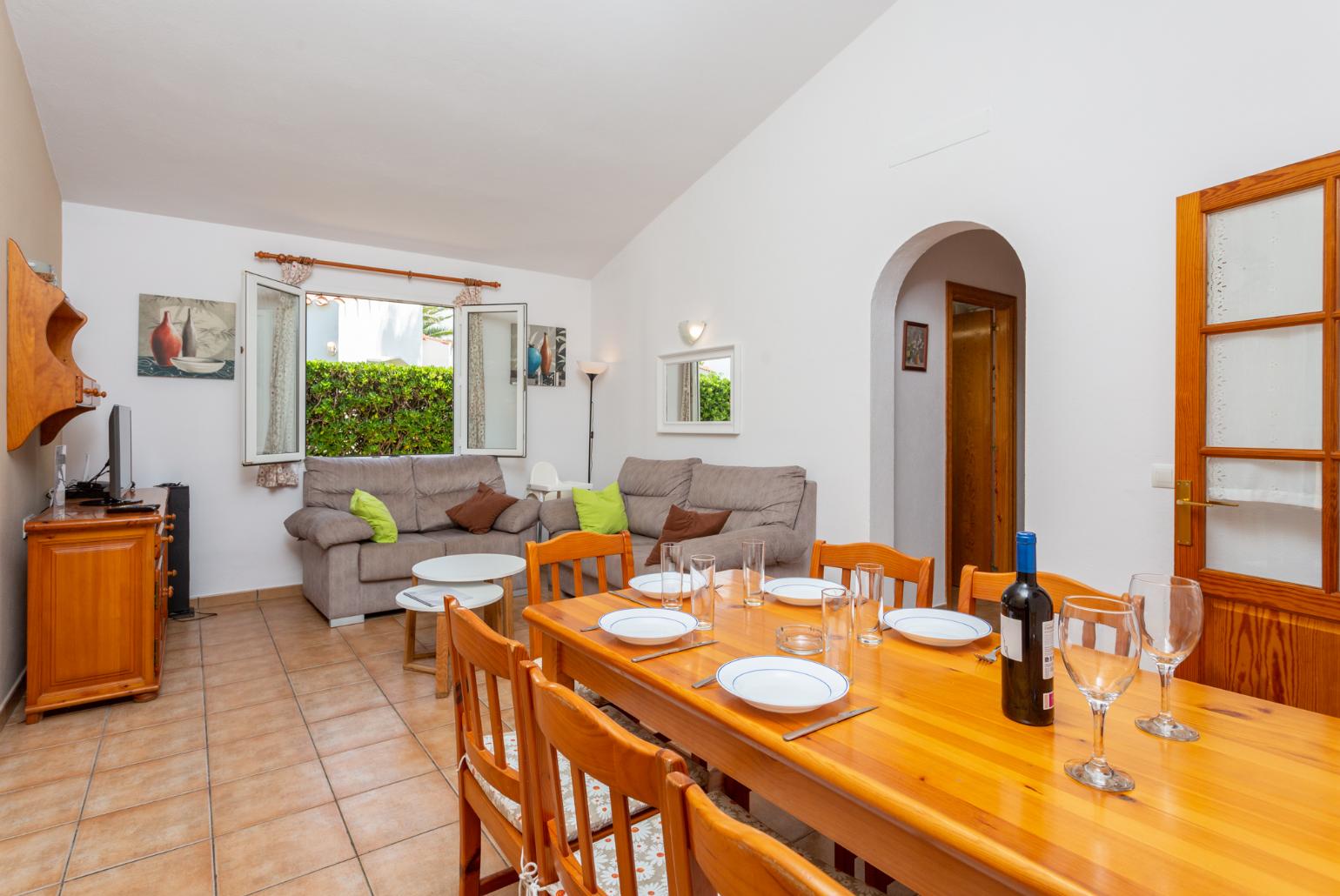 Living room with sofas, dining area, WiFi internet, satellite TV, and terrace access