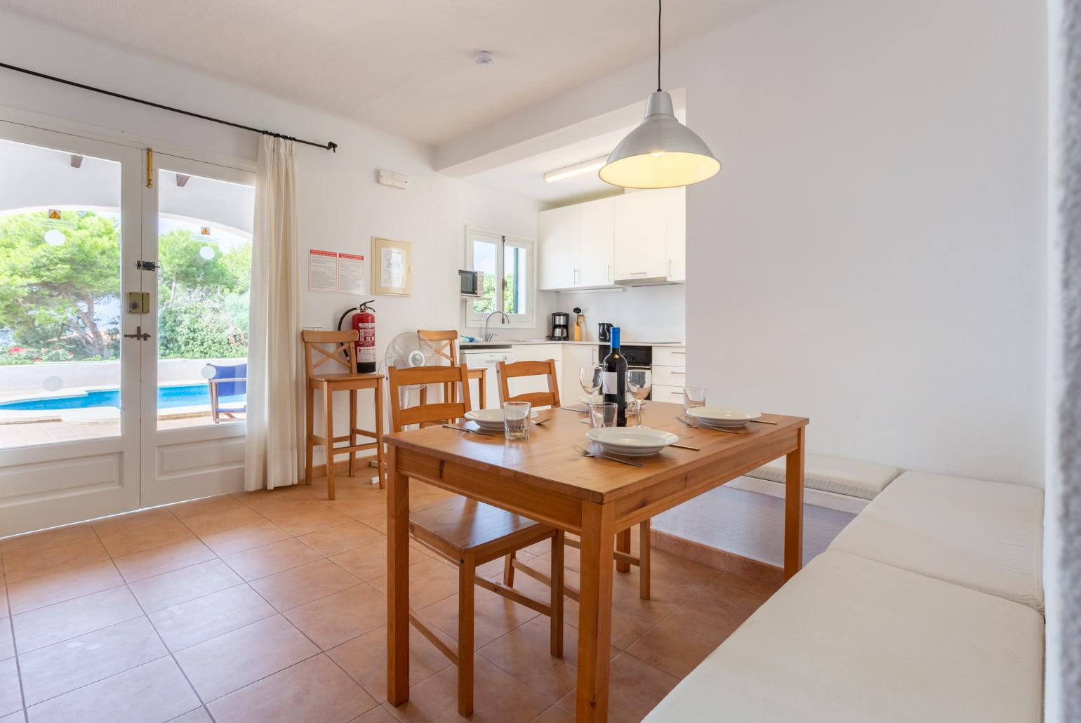 Open-plan living room with sofas, dining area, kitchen, WiFi internet, satellite TV, and terrace access