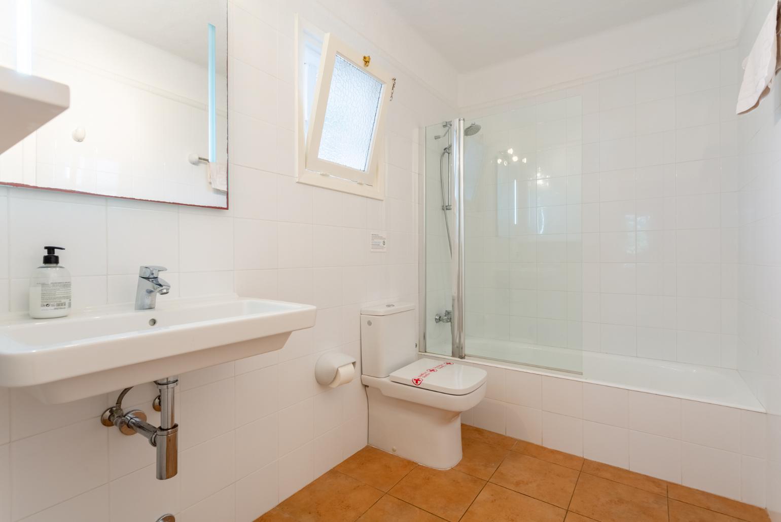 En suite bathroom with bath and shower