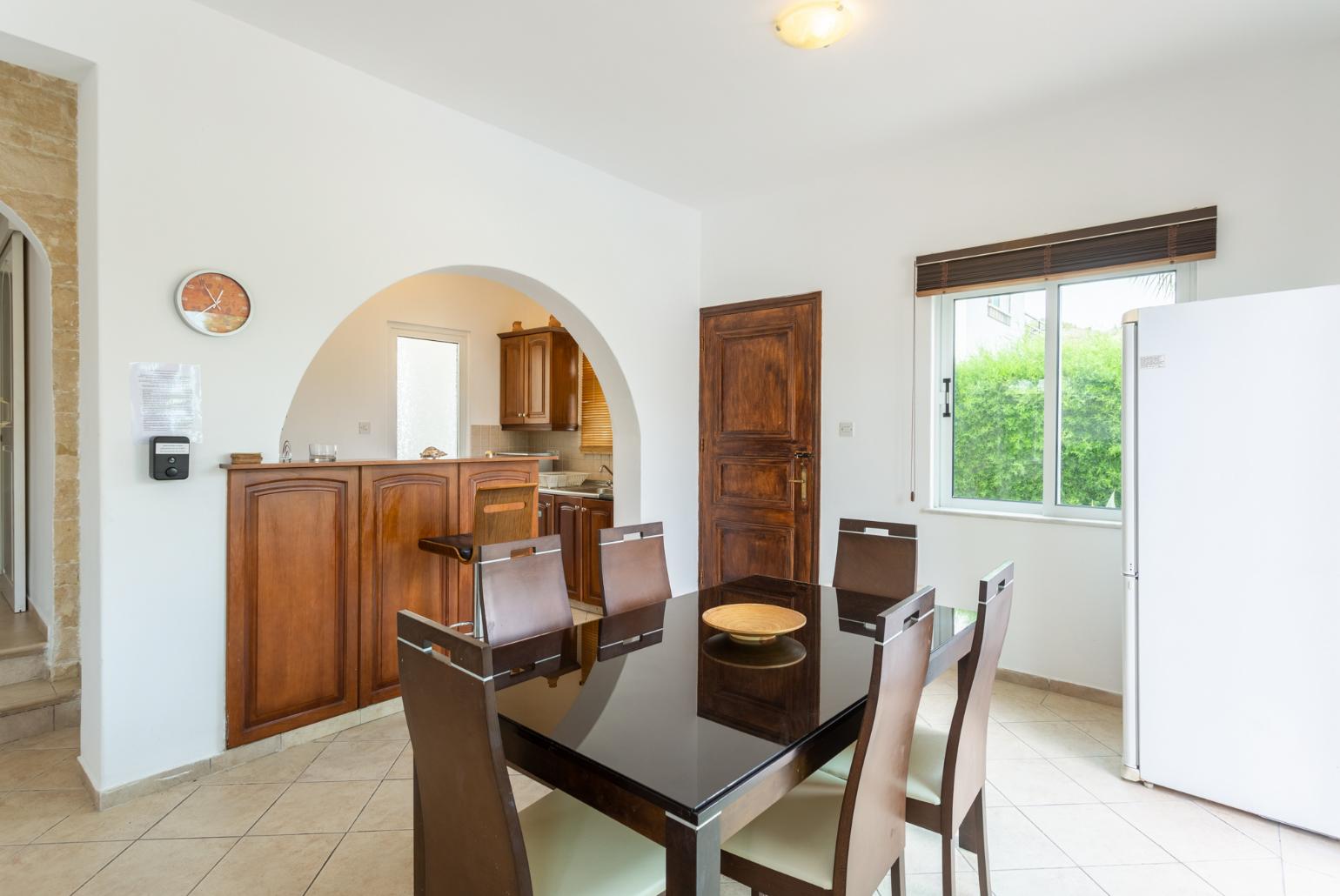 Open-plan living room with sofas, dining area, kitchen, ornamental fireplace, WiFi internet, satellite TV, and pool terrace access