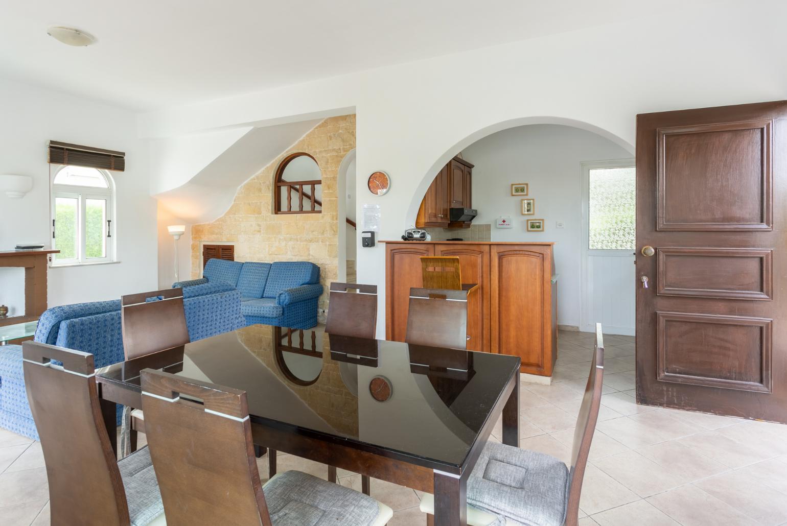 Open-plan living room with sofas, dining area, kitchen, ornamental fireplace, WiFi internet, satellite TV, and pool terrace access