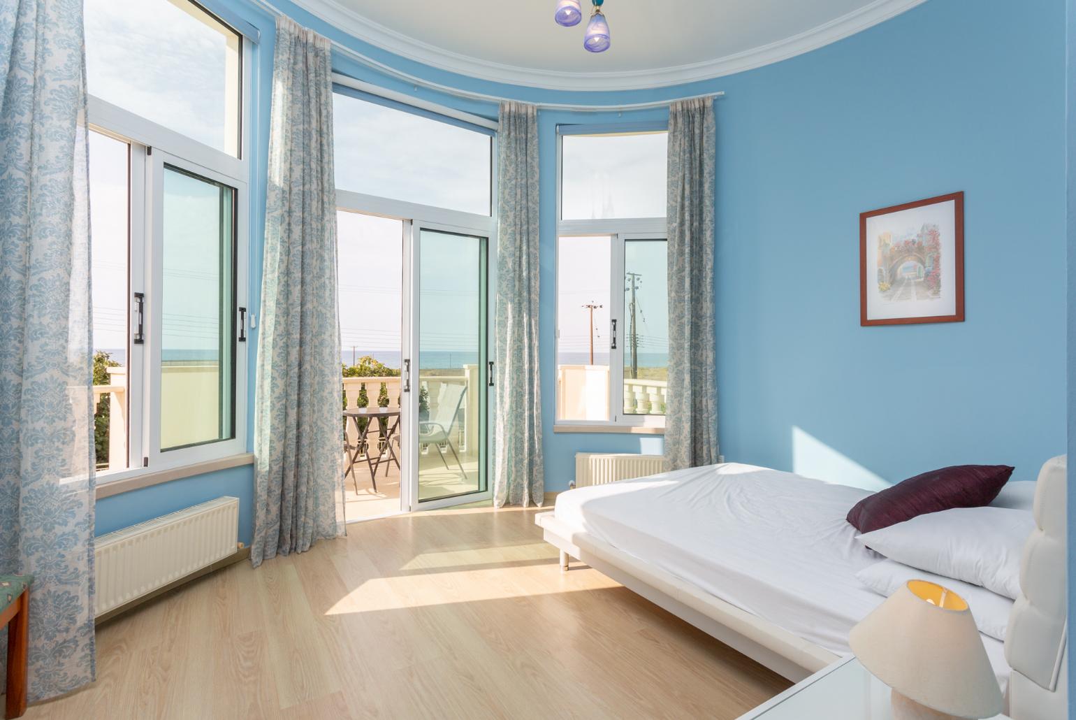 Double bedroom with en suite bathroom, A/C, and balcony access with sea views