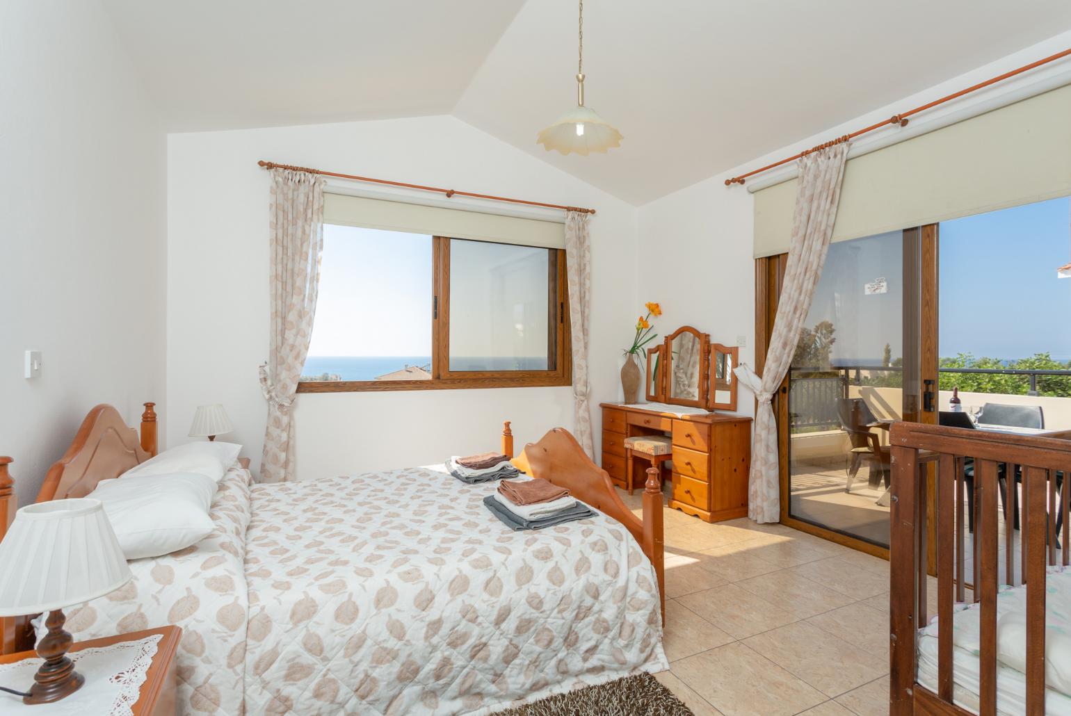 Double bedroom with en suite bathroom, A/C, and upper terrace access with sea views