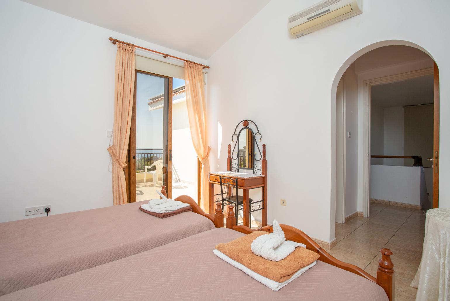 Twin bedroom with en suite bathroom, A/C, and upper terrace access with sea views